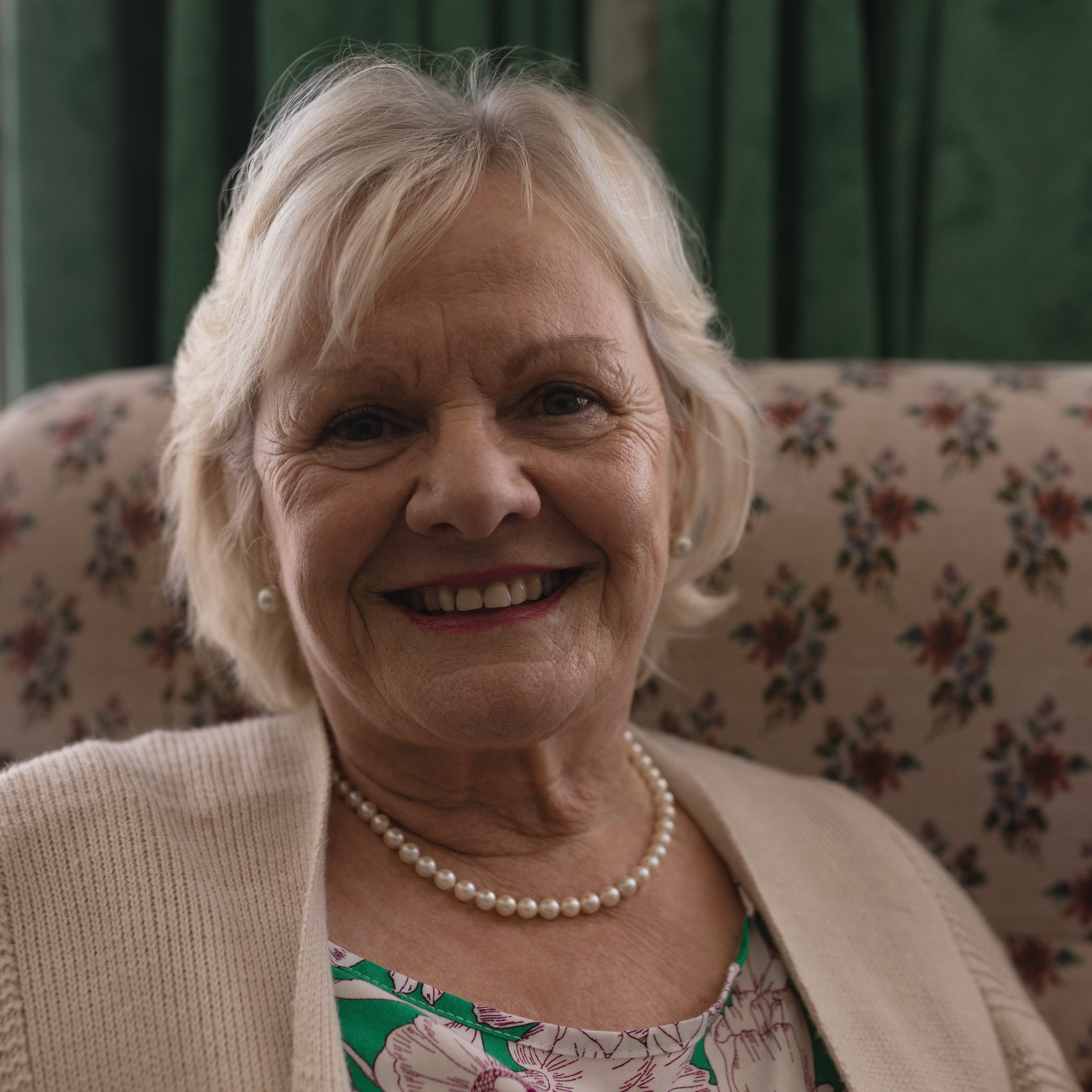 Close up of active senior woman relaxing and smilling in living room at home